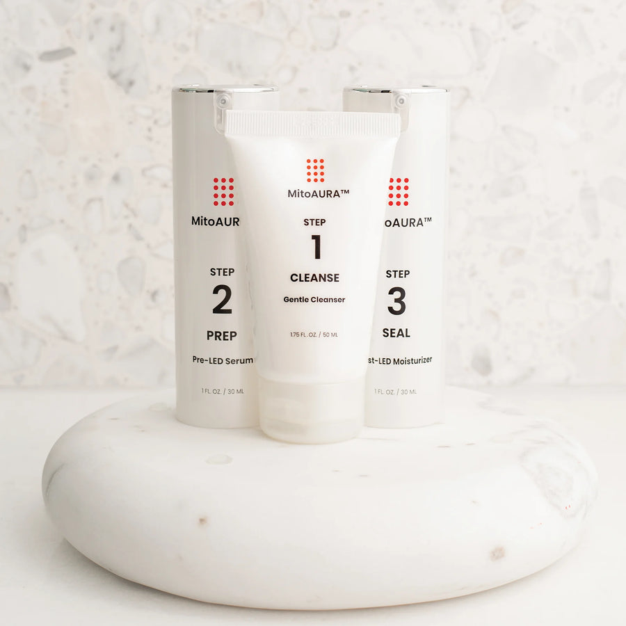 MitoAURA 3-step skincare system: Step 1 Cleanse, Step 2 Prep and Step 3 Seal on a white marble stand