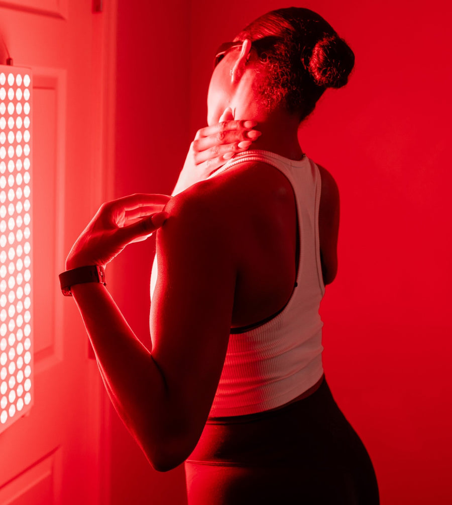 woman in front of red light panel for self-care.