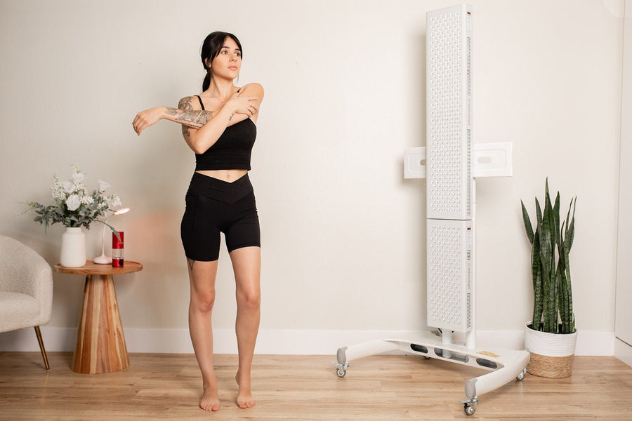 Girl stretching in front of red light panels